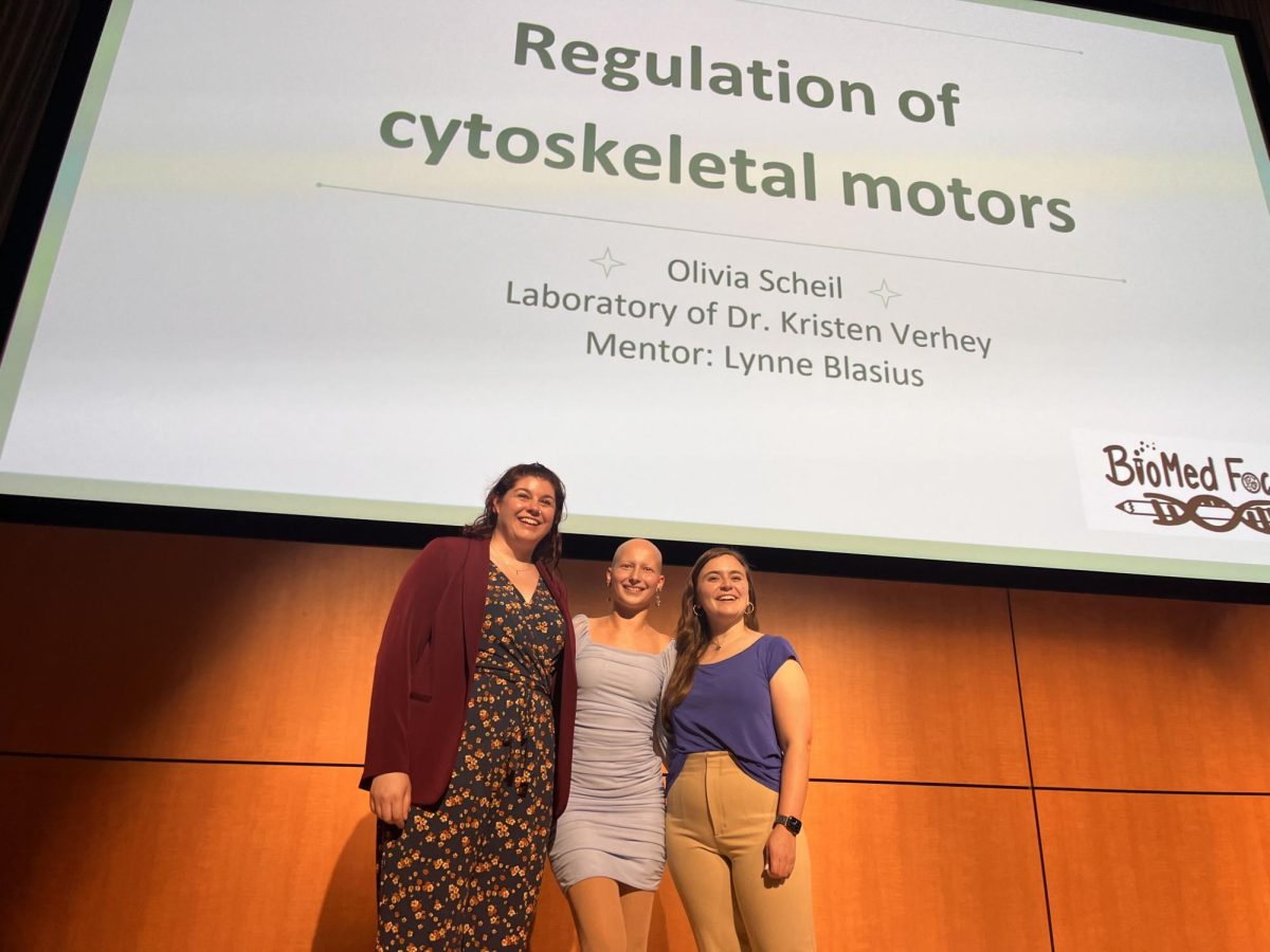 BioMed Focus coordinator Megan Radyk (left), Scholar Olivia Scheil (center), and coordinator Sarah Steiner (right) are ready to begin presenting Olivia Scheil's research at the BioMed Focus symposium. 