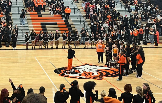 Mrs. Herrmann, the choir director, leads the choir class in the National Anthem during the Homecoming Pep Assembly on October 11th, 2024.