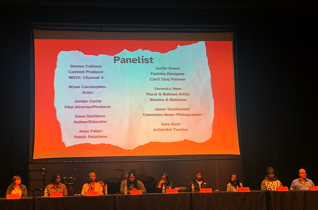 Panelsists Sara Sych, Veronica Horn, Dana Davidson, Jordan Currie, Sheree Calhoun, Bryan Carstarphen, Anya Fuller, Justin Green, and Jason Strzalkowski share career experiences and advice at Belleville High School's December Arts and Communications Career Pathway Assembly.