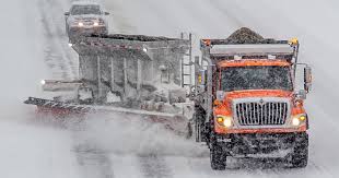 Michigan "tow plow" carrying and spreading tons of salt onto our roadways to prepare roads for bad weather and improve their conditions.