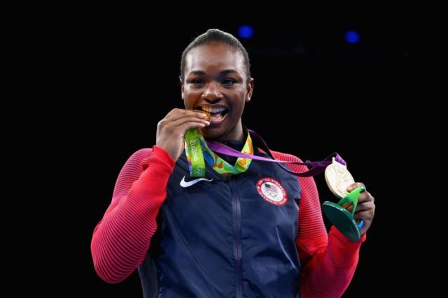 Claressa Sheilds happily shows her two Olympic gold medals.