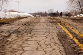 One of many bad/destroyed roads in the state during wintertime. Lack of maintenance caused this road and many others to stay in this condition, which can impact alignment and tires on vehicles.