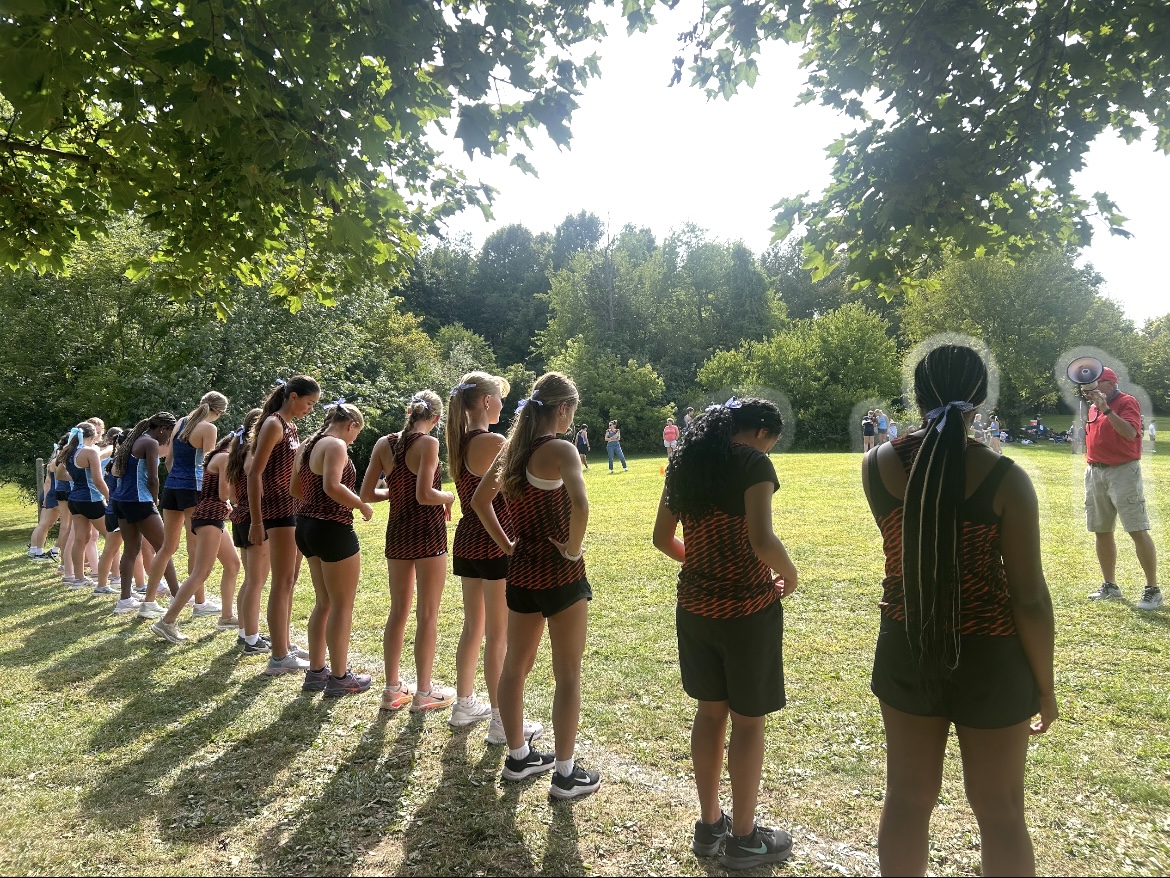 Belleville Girl's Cross Country Team stands at the starting line on September 9th, 2025 at their meet against Livonia Stevenson located at Cass Benton Park.