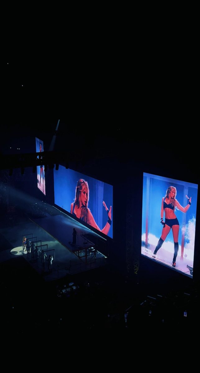 Tate McRae at her Detroit, Michigan show at Little Caesar's Arena performing her song "Revolving door".