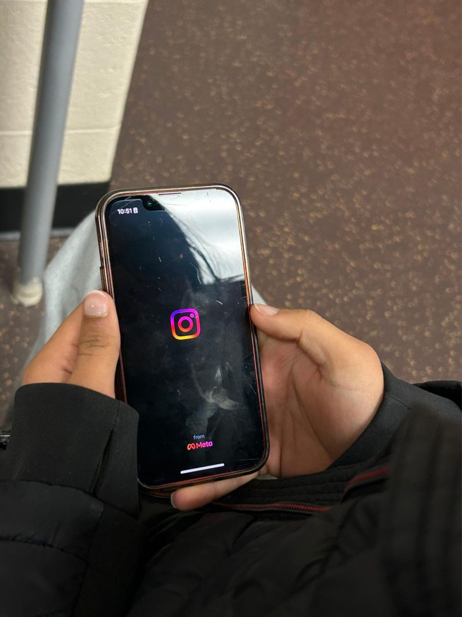 Student opening Instagram, exhibiting phone addiction.