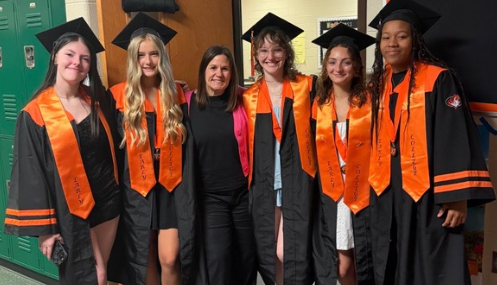 Ms. Sprague stands with the class of 2025 graduates who started their early college journey as sophomores. These students are currently in their final year of early college.