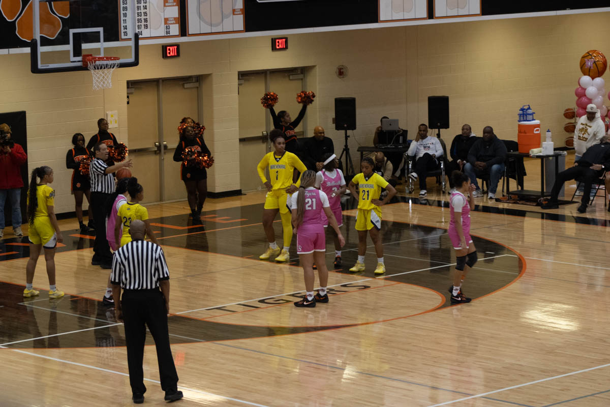 Varsity girl's basketball showed up in pink uniforms at a game.